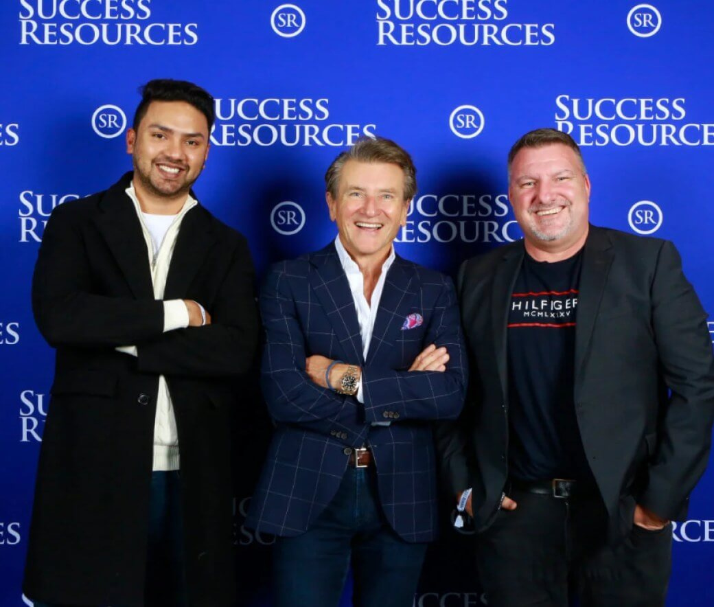 Two team members with a guest speaker at a Success Resources event